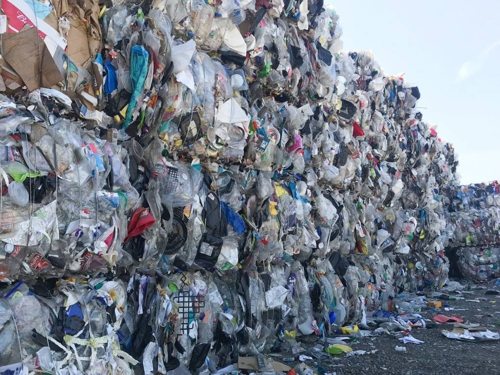 a very large pile of plastic at a recycling facility
