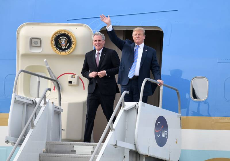 two white men get off a private plane