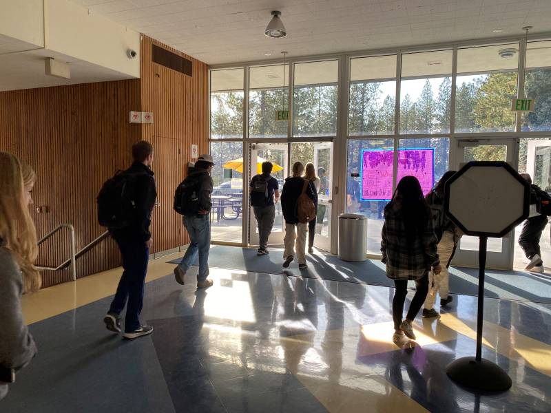 students walk in a high school