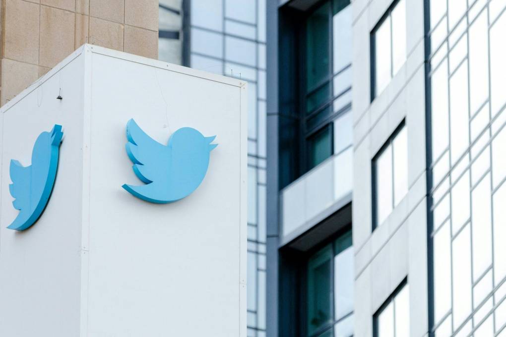 a blue bird symbol, the company logo for Twitter, is seen on the outside of the company's building
