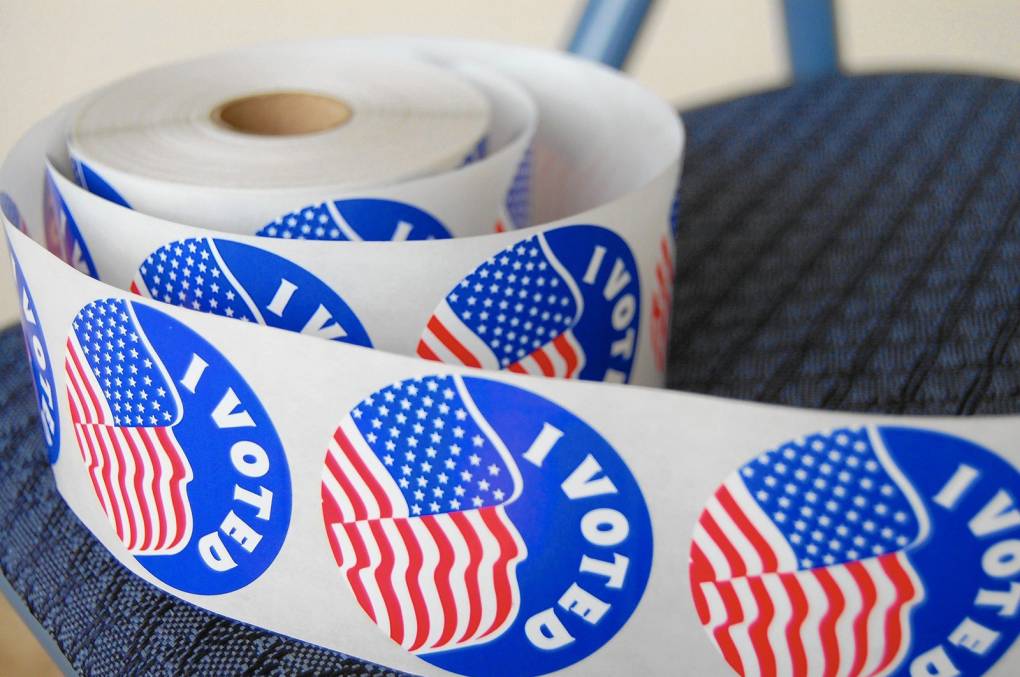 A roll of red, white and blue stickers that say "I voted" with the American flag.