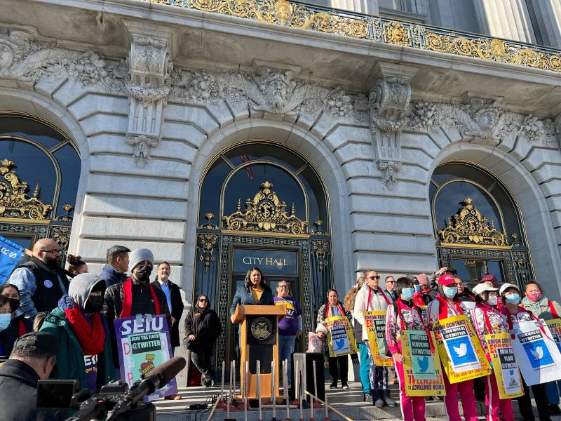 A crowd of protesters and the mayor gather outside San Francisco City Hall