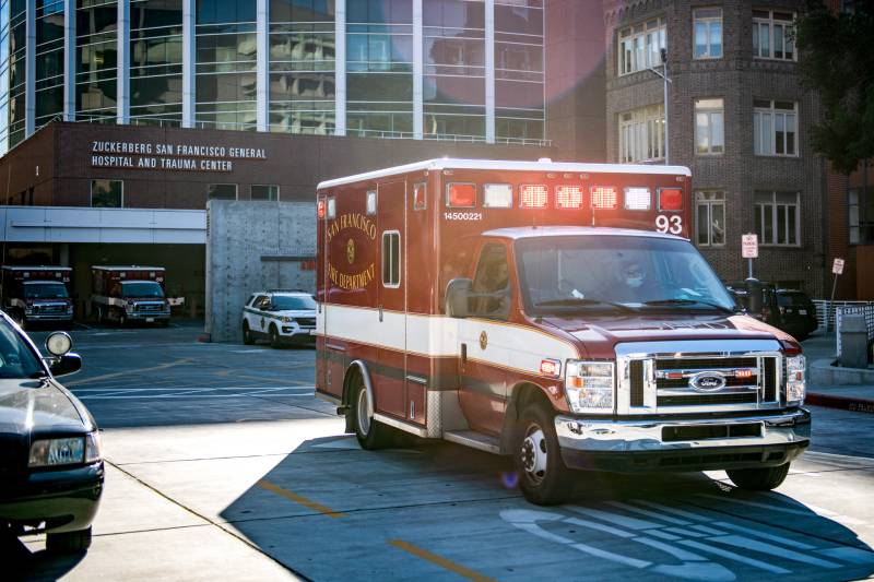 An ambulance outside of a hospital.