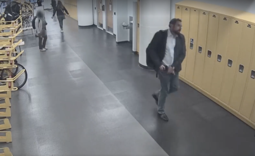 A man walks down a hallway.