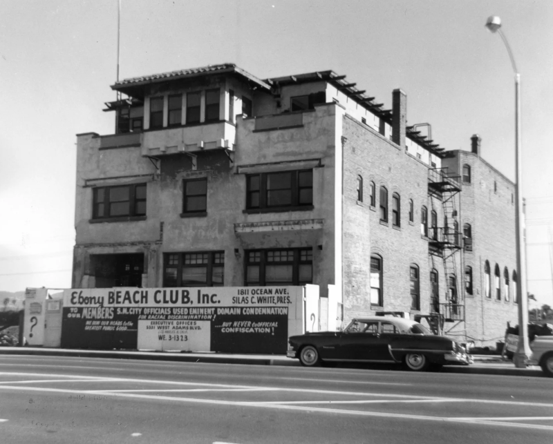 A black and white photo of a building with a sign that reads "Ebony Beach Club, Inc."