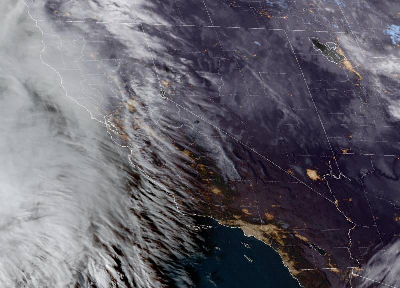 Satellite image of California outlined on a mad with white cloud systems covering the entire northern part of the state.