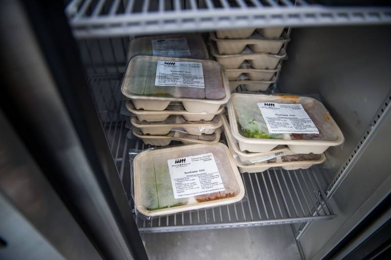 Pre-packed meals in a fridge awaiting delivery.