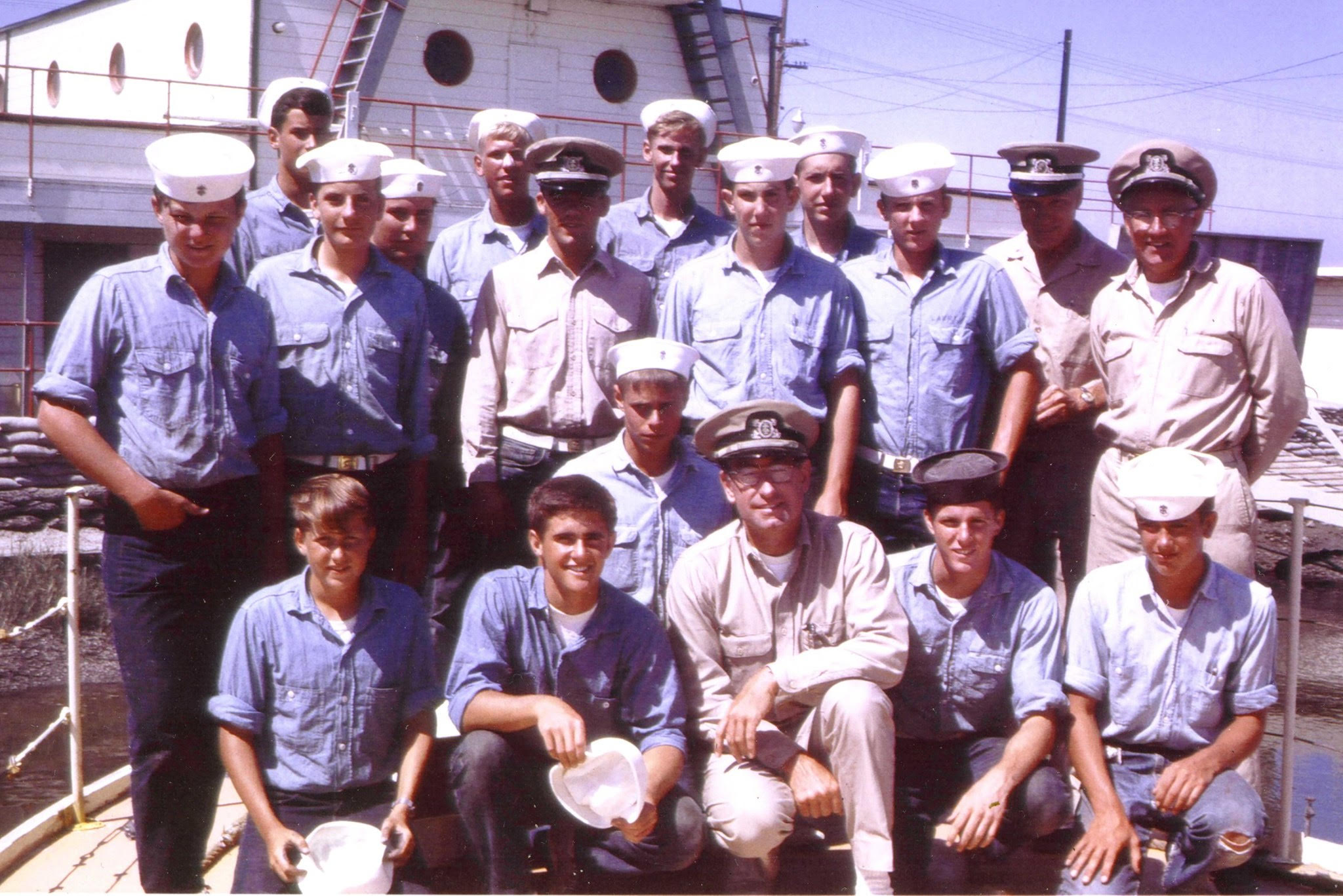 A class photo taken outdoors of young, teenage boys looking jaunty in sailor outfits.