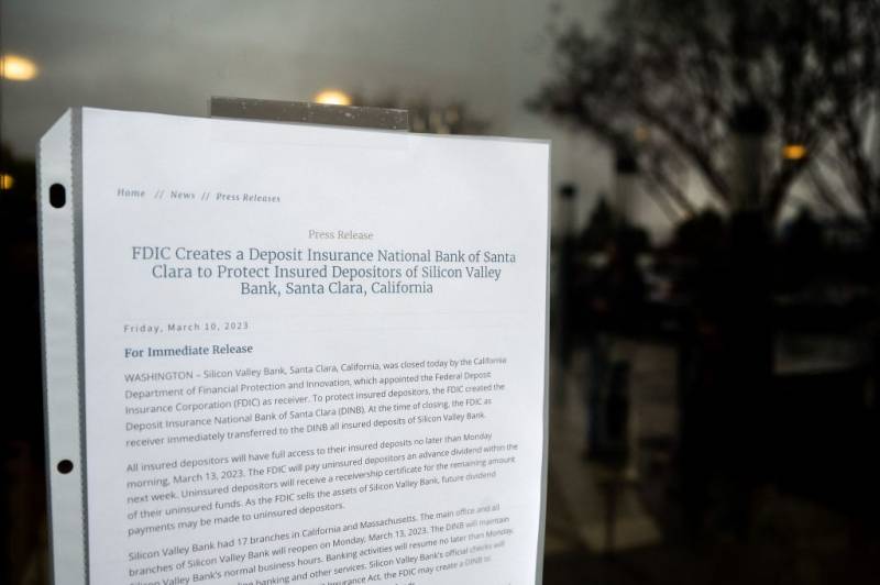 A white notice is taped to the glass door of SVB headquarters.