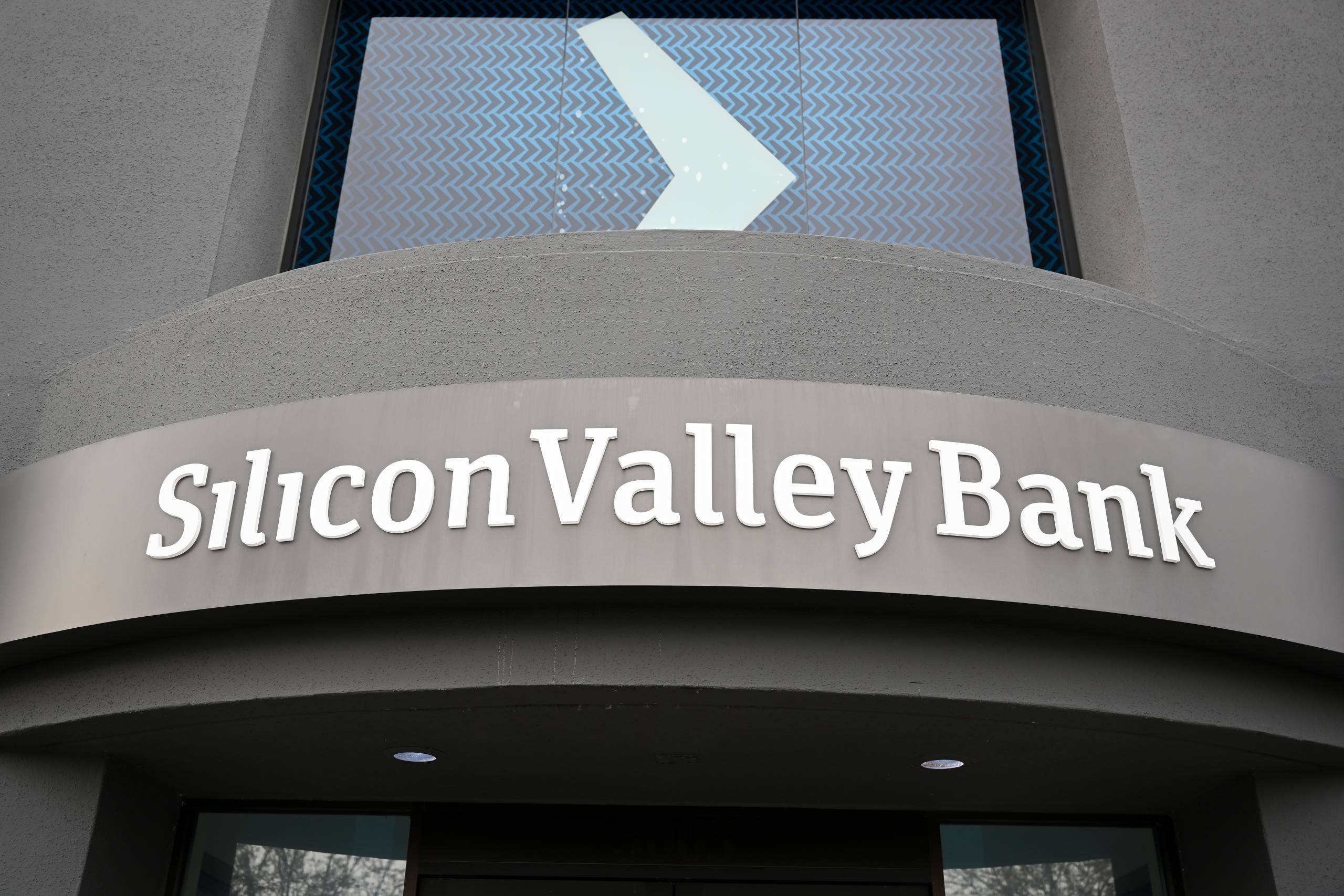 The exterior signage of Silicon Valley Bank with white letters on a gray building.