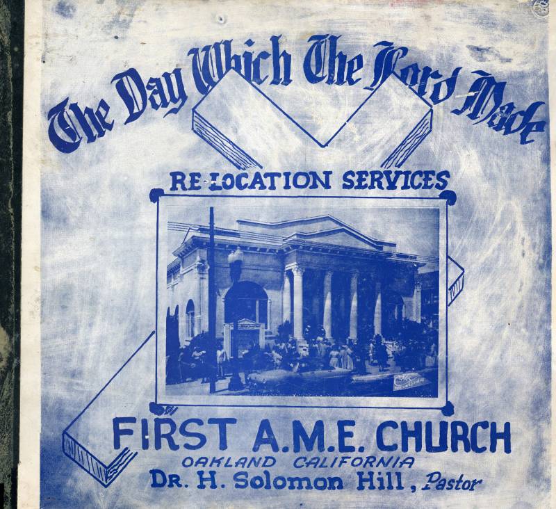 An archival photo of a scrapbook cover with blue lettering and image of a building with a cross diagonally in the background.
