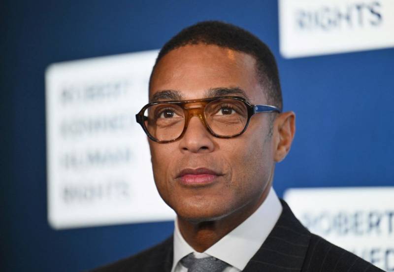 Headshot of an African American man with glasses and a suit looking away from the camera.