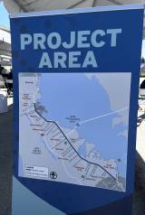A blue and white project map with roads outlined, shown in shade outdoors.