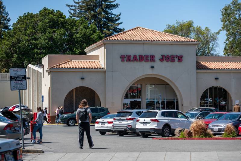 The view of a Trader Joe's store and the parking lot in front.