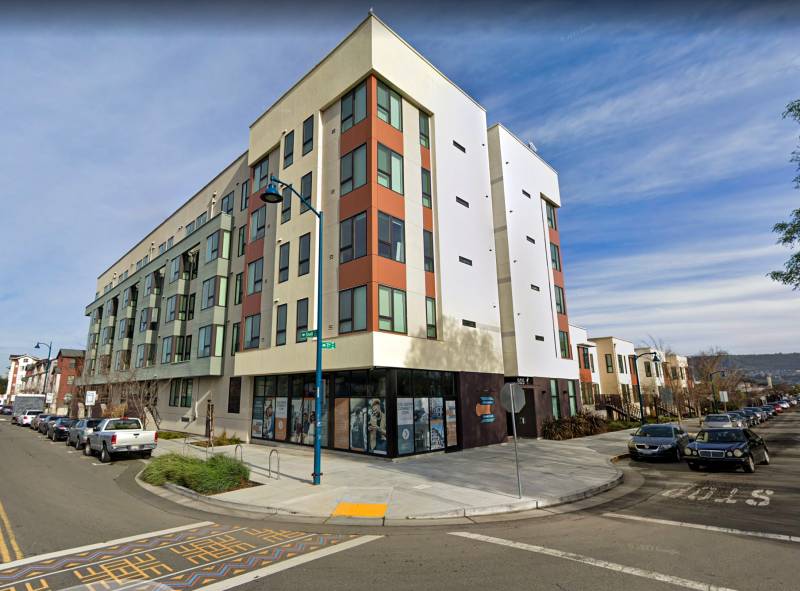 A street-level view of new five-story apartment building in East Oakland.