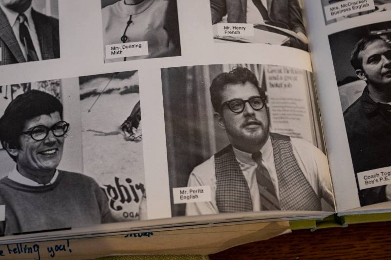 A vintage photo from a page in a yearbook of a white man with glasses wearing a tie, white shirt and vest. 