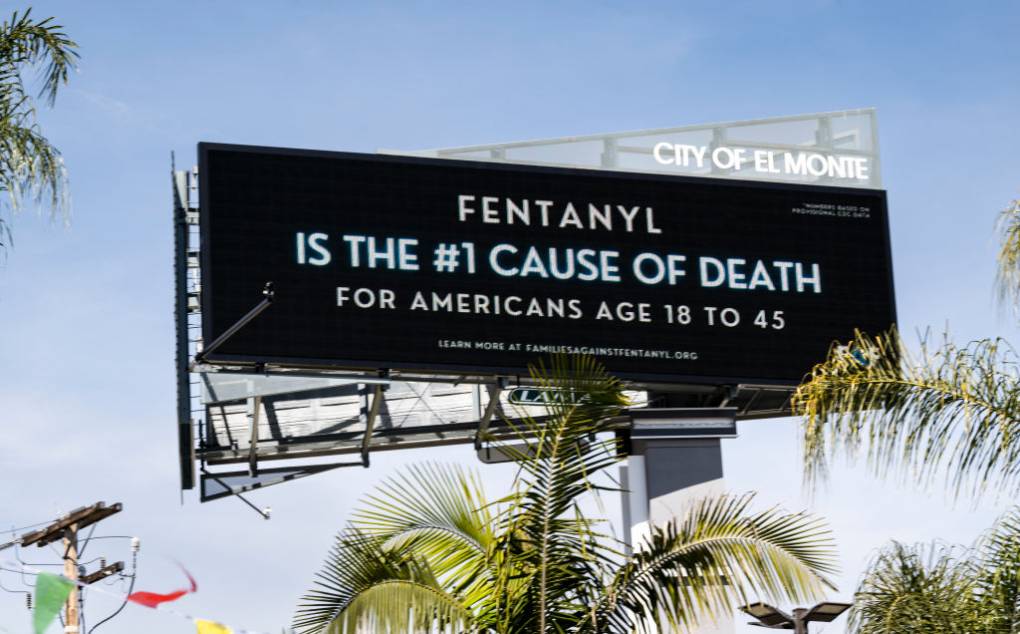 A billboard sign reads "Fenanyl is the #1 cause of death for Americans Age 18 to 45."
