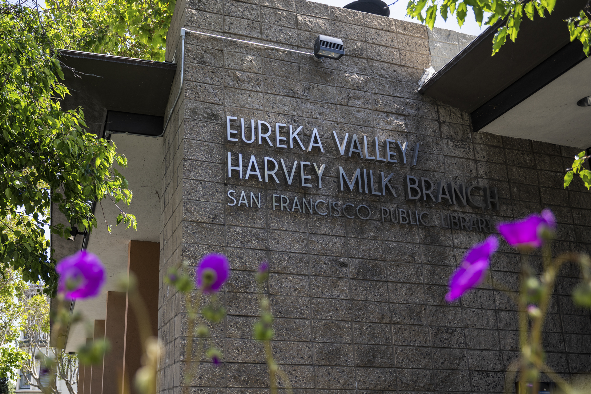 Writing on a brick wall that reads "Eureka Valley Harvey Milk Branch San Francisco Public Library"