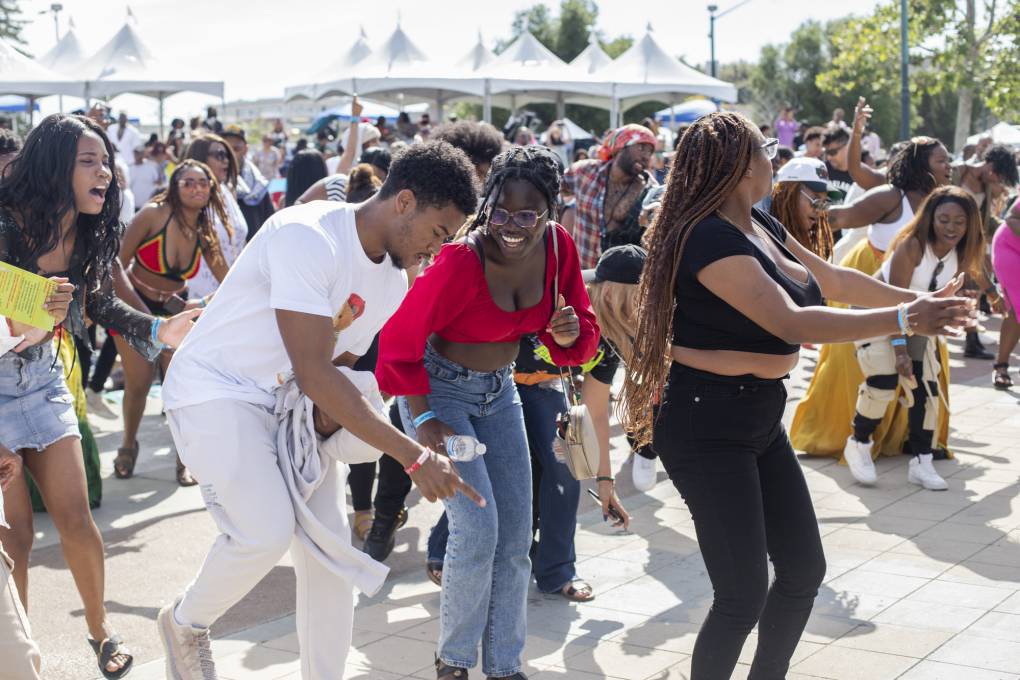 People dance at Lake Merritt as part of the 14th annual Fam Bam Afrocentric Juneteenth festival in Oakland on June 17, 2023.