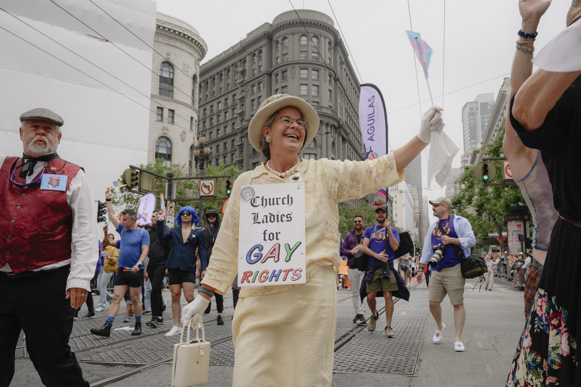 Cathy Webber, 66, waves a trans flag as she walks down Market Street in downtown San Francisco during the Pride parade on June 25, 2023.