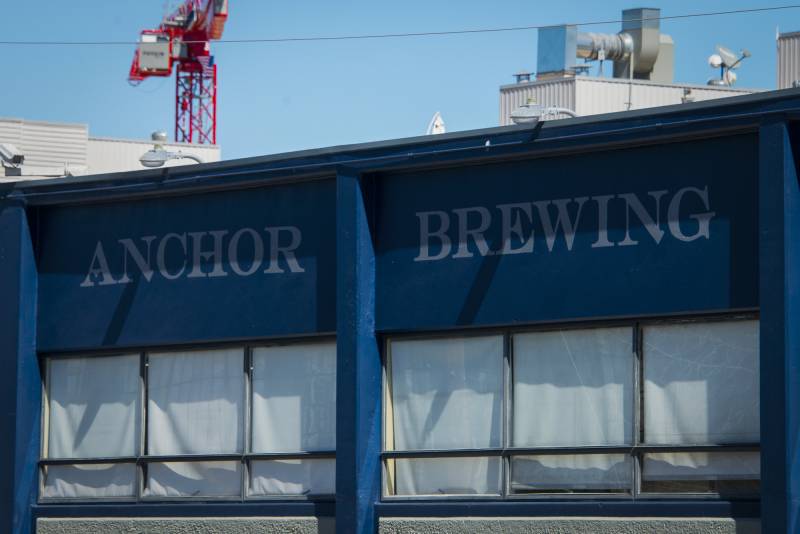 Signage on the top of a multistory building reads "Anchor Brewing."