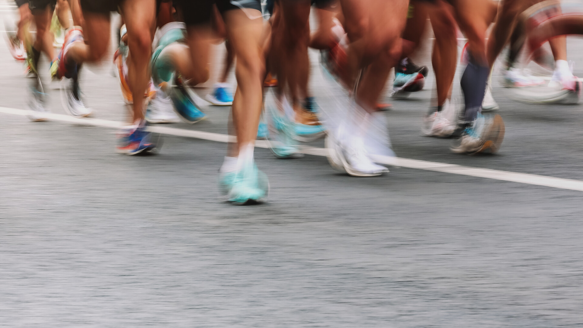 An image of several people's legs photographed in a running motion.
