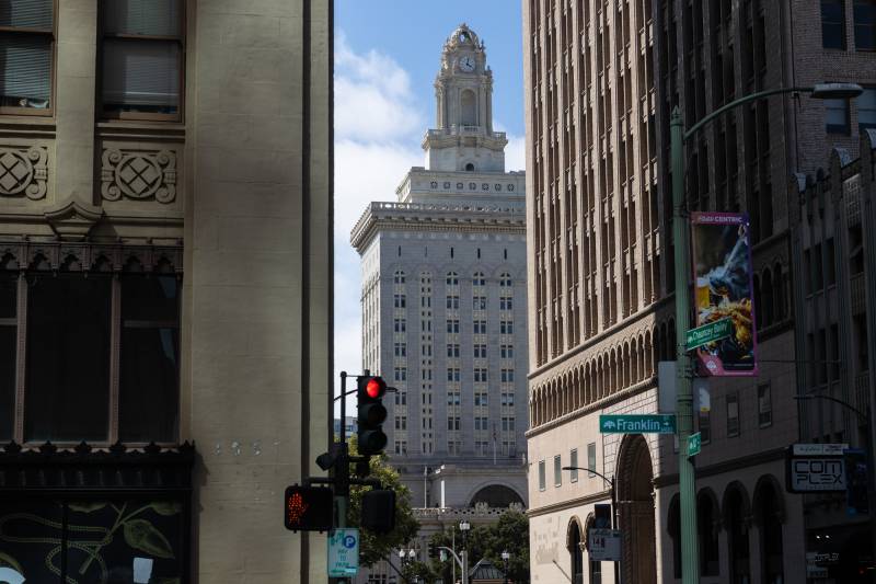 Oakland's City Hall is seen in between other tall buildings.