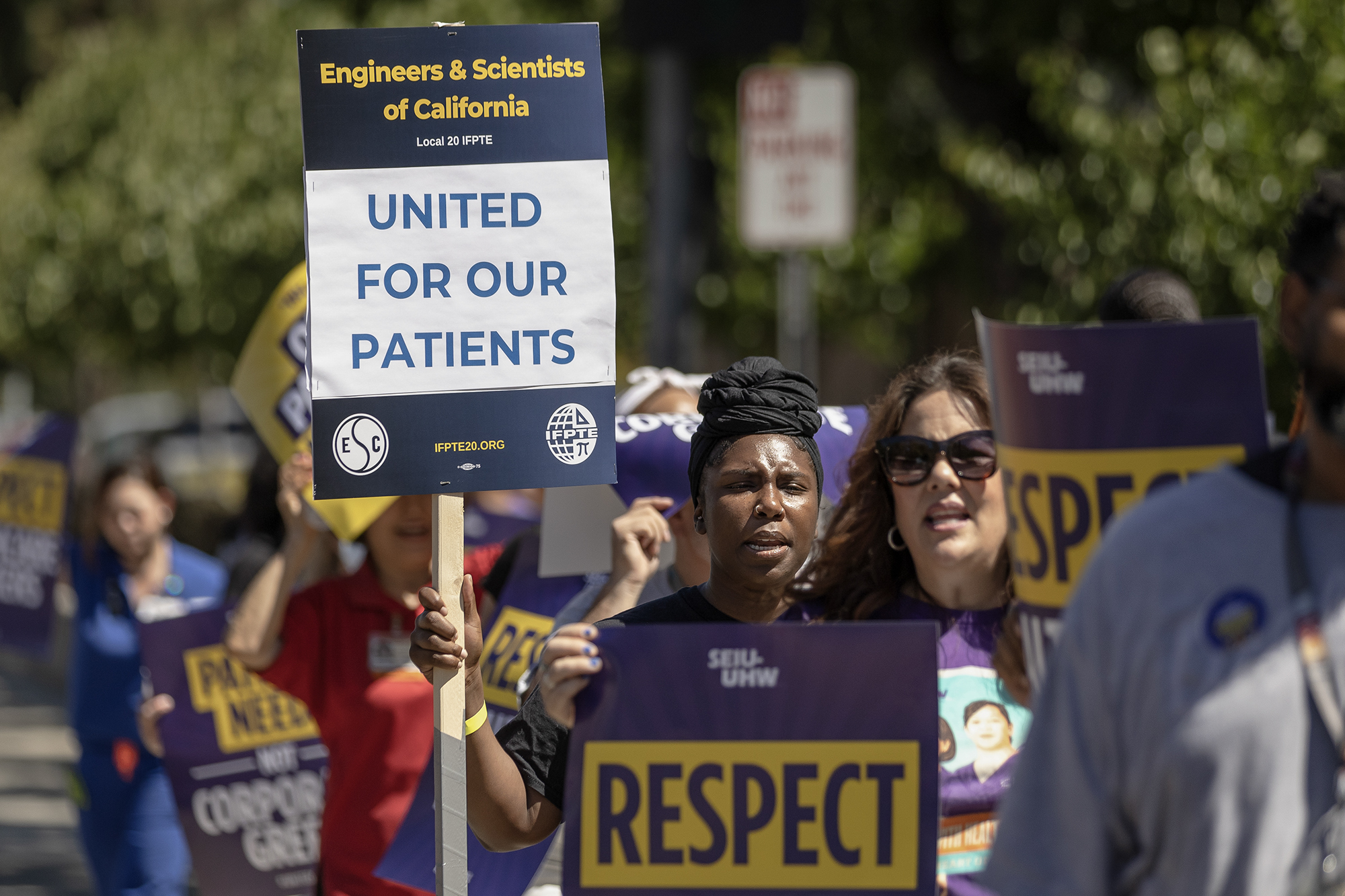 Health Care workers hold signs that read, "Engineers & Scientists of California United for Our Patients."