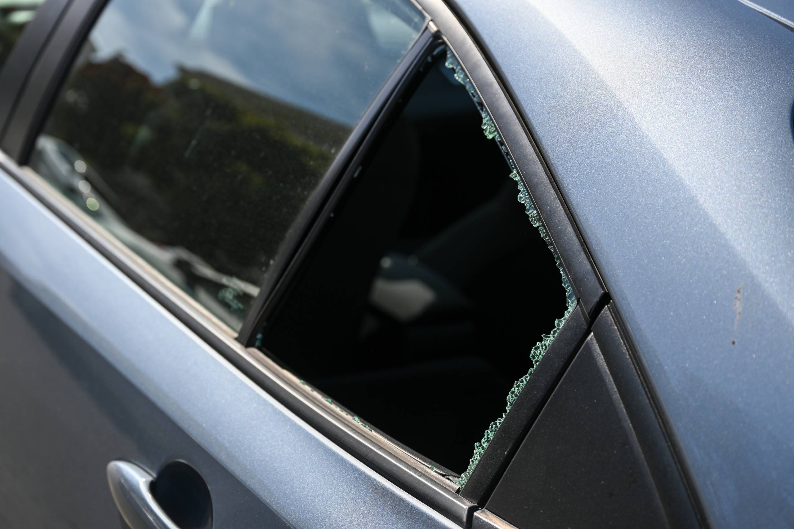 The rear window of a car that is completely shattered.