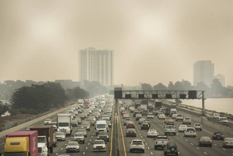 A highway filled with vehicles is seen surrounded in haze.