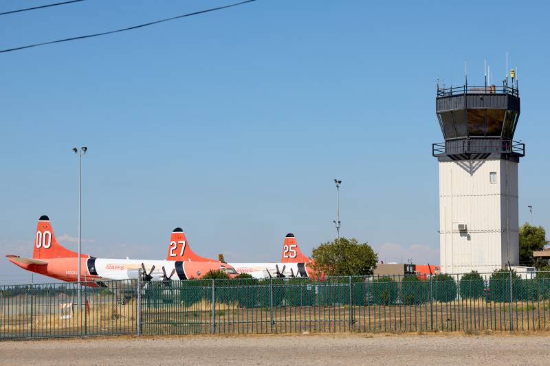 Aircraft and control tower in the distance.