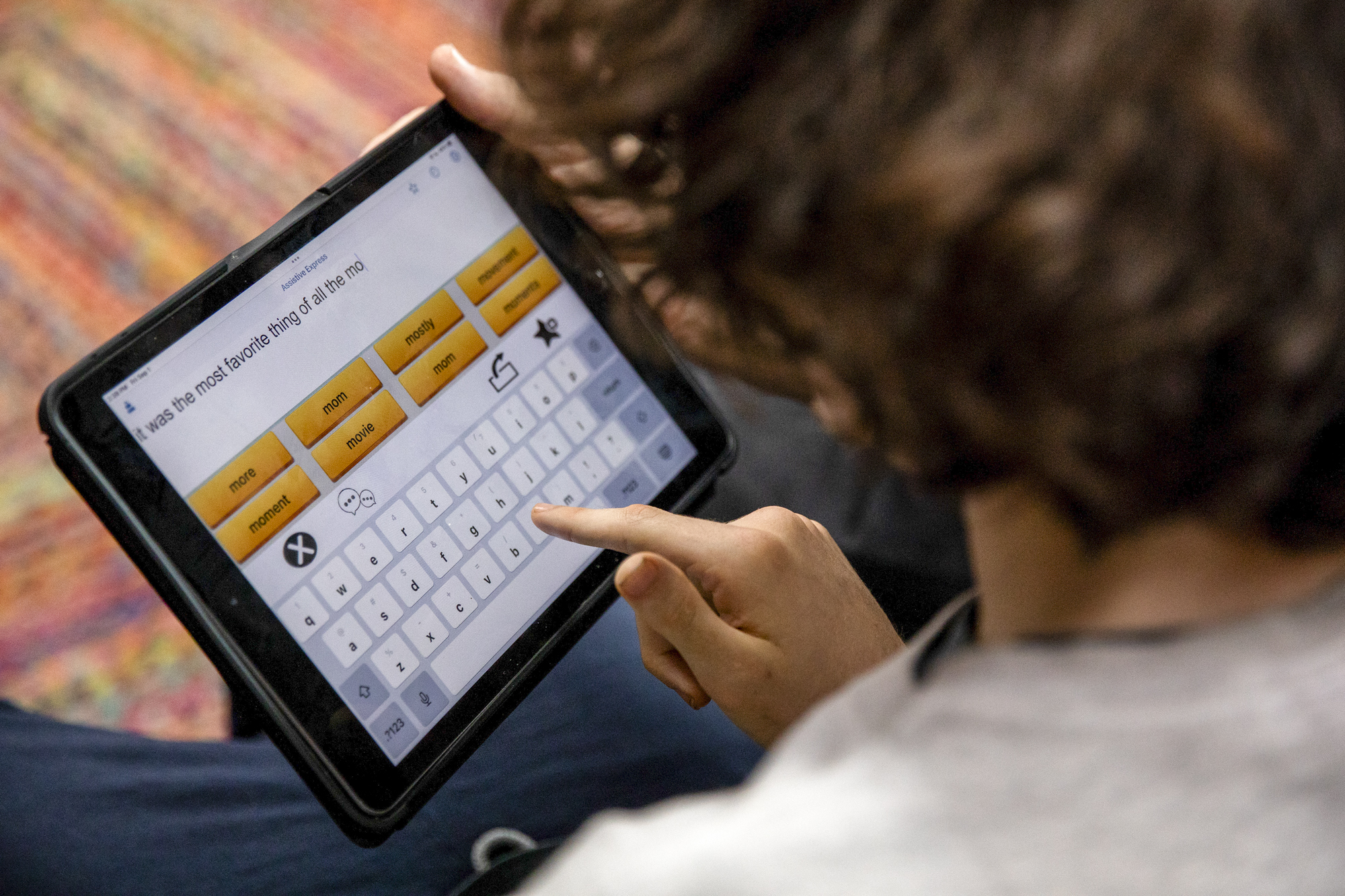 A person uses an ipad to type a sentence.