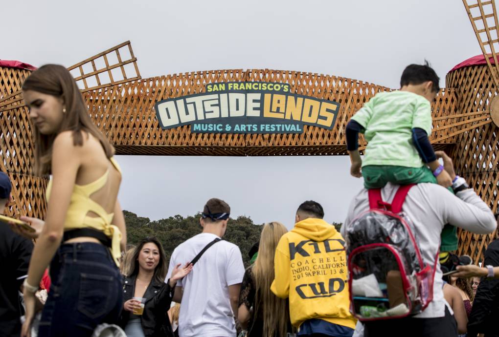 Fans pose under the iconic windmill arch during day two of the Outside Lands Music Festival at Golden Gate Park in San Francisco on August 10, 2019.