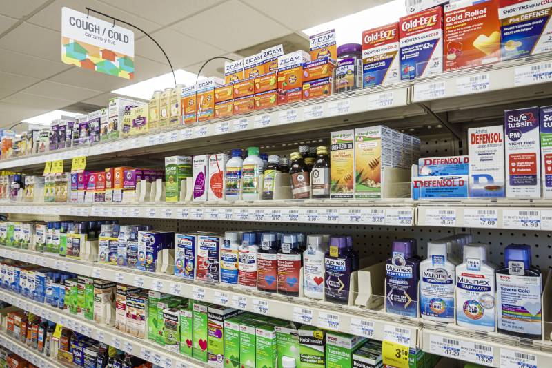 an aisle of over-the-counter cold medications