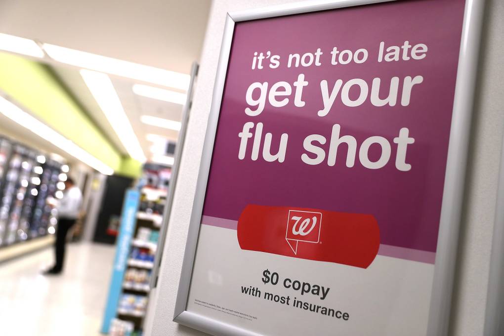 A sign inside a Walgreens pharmacy that reads, "It's not too late to get your flu shot."