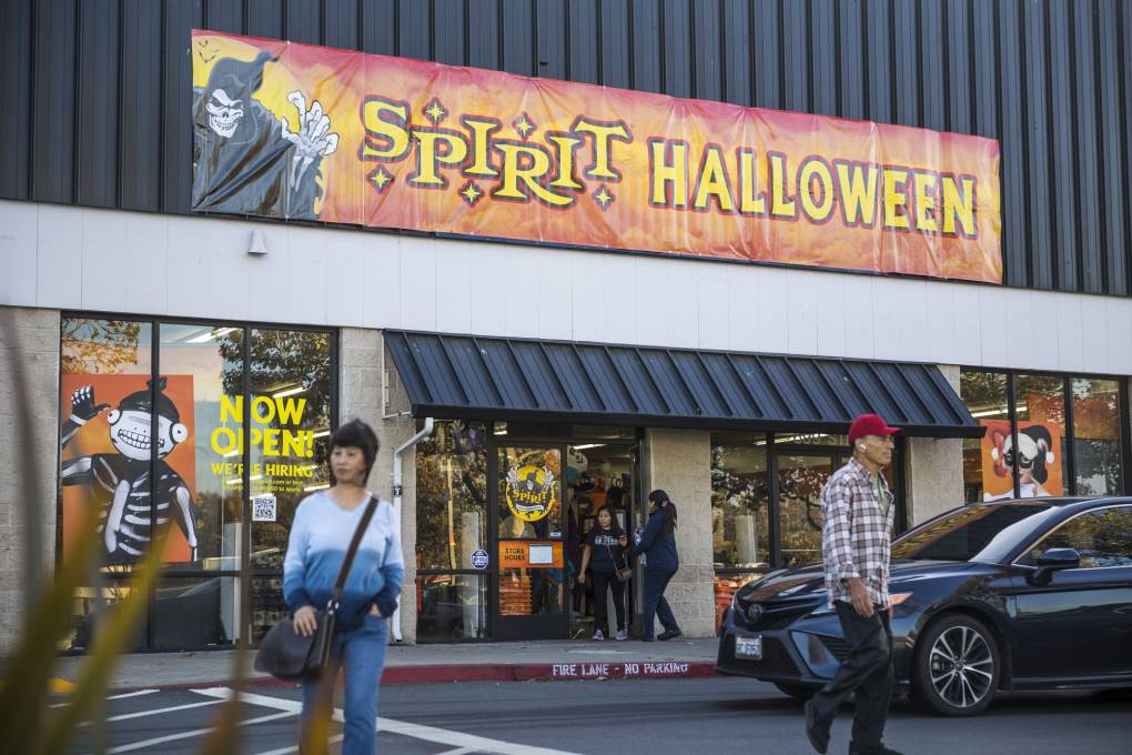 The exterior of a storefront with a large sign over the entrance that reads "Spirit Halloween."