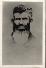 Old black and white photo of a man with a beard.