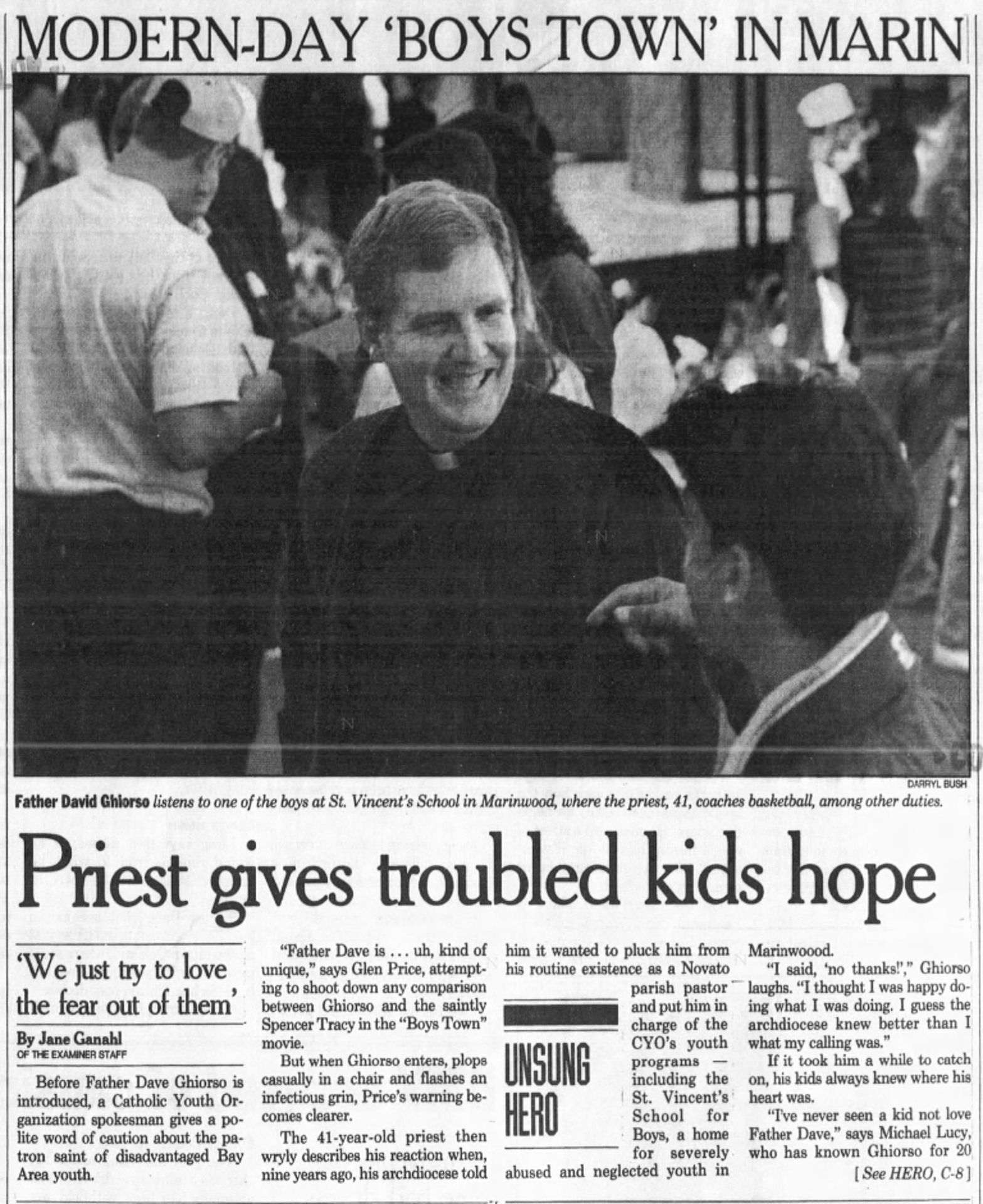 A newspaper clipping with a photo of a priest smiling while talking to a person facing him.