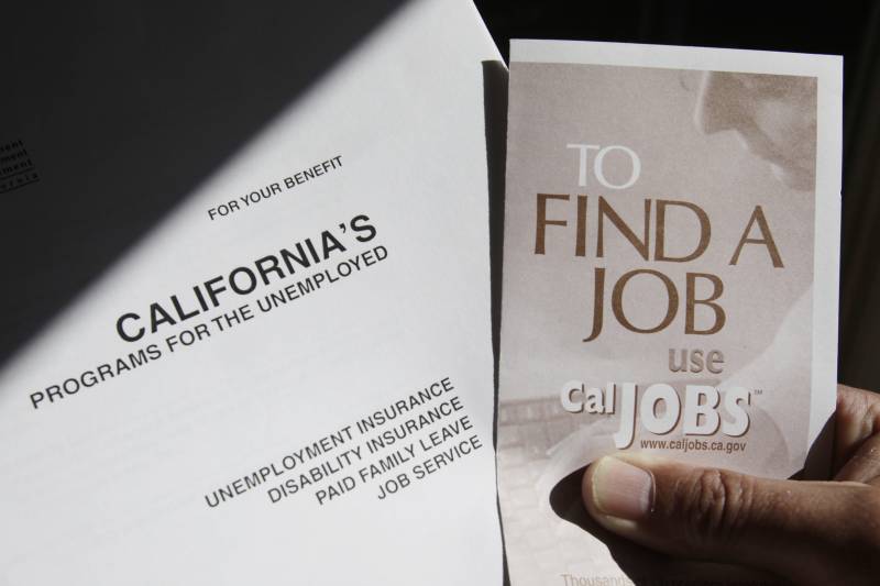 Two pieces of paper with a hand holding the brochure on the right that says "To Find a Job."