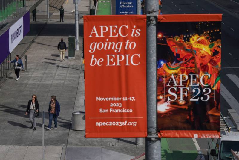 A street scene in San Francisco from above, with an advertising banner in the foreground that reads "APEC is going to be Epic."