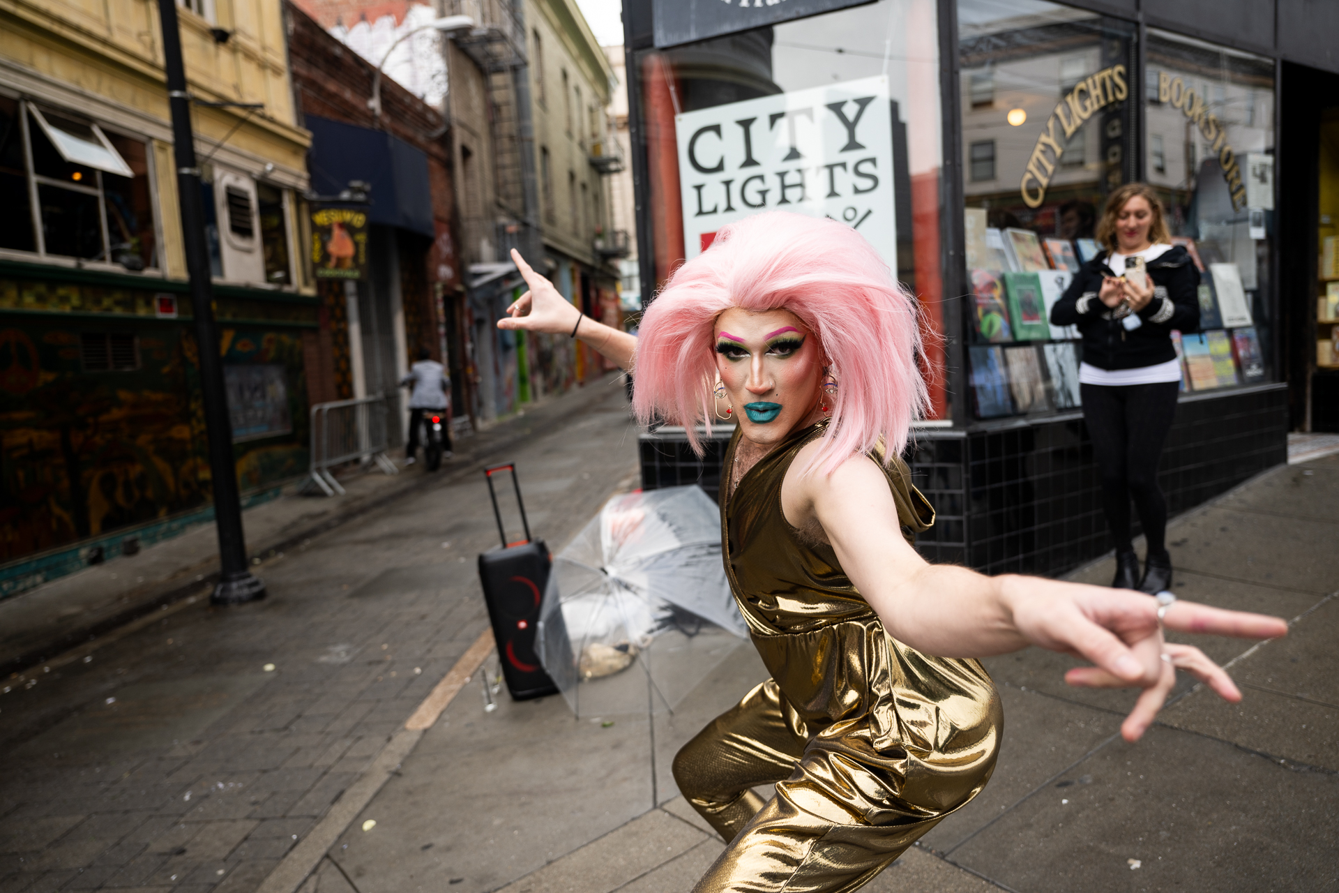 A drag artist performs in front of City Lights bookstore in North Beach.