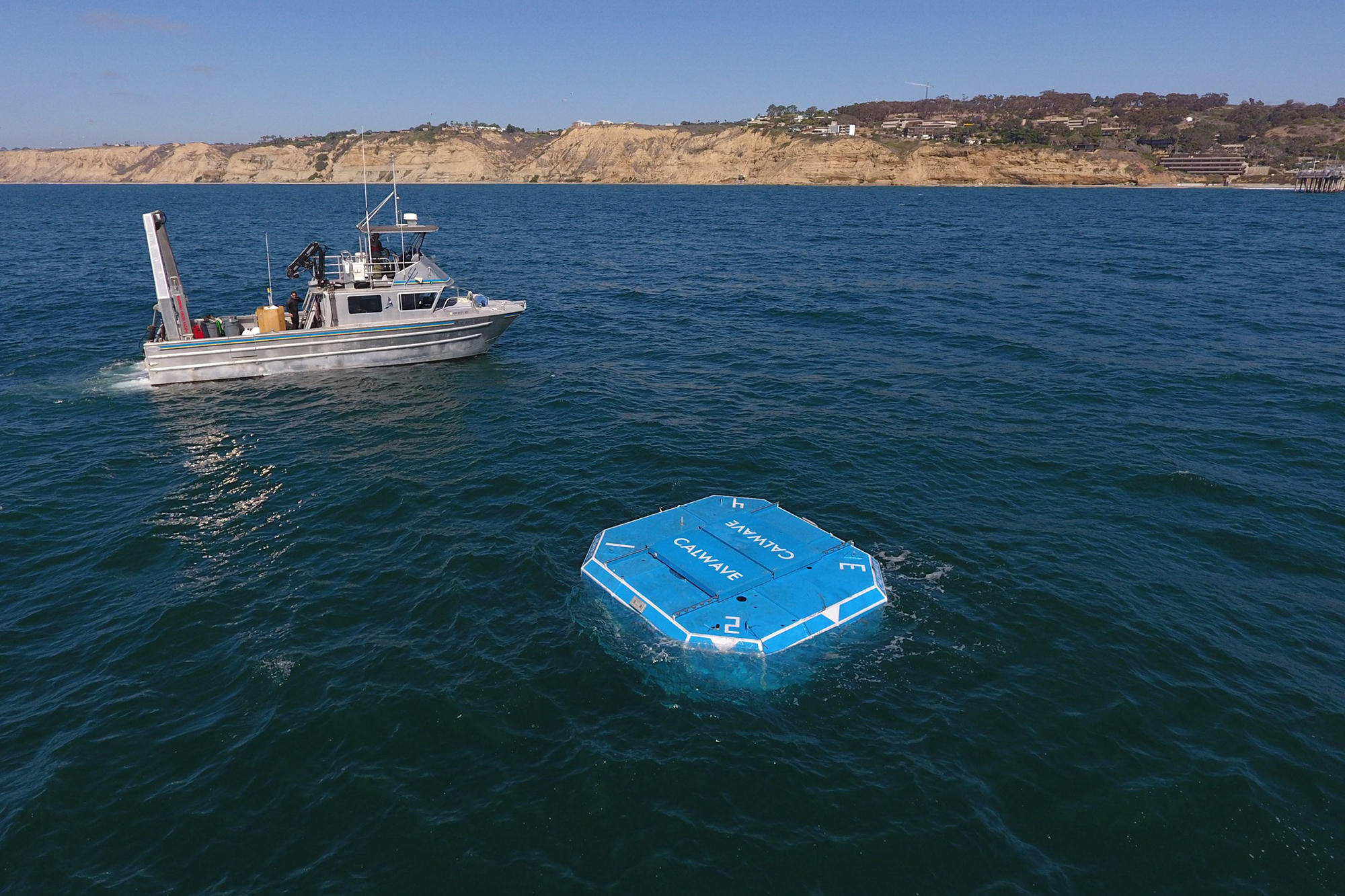A piece of high-tech equipment is seen floating in the open ocean where it will be submerged in order to detect wave energy.