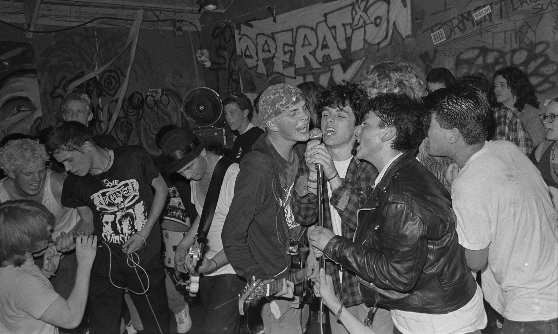 Billie Joe Armstrong (third from right) sings with Operation Ivy onstage at 924 Gilman, circa 1988.  Photo: Murray Bowles