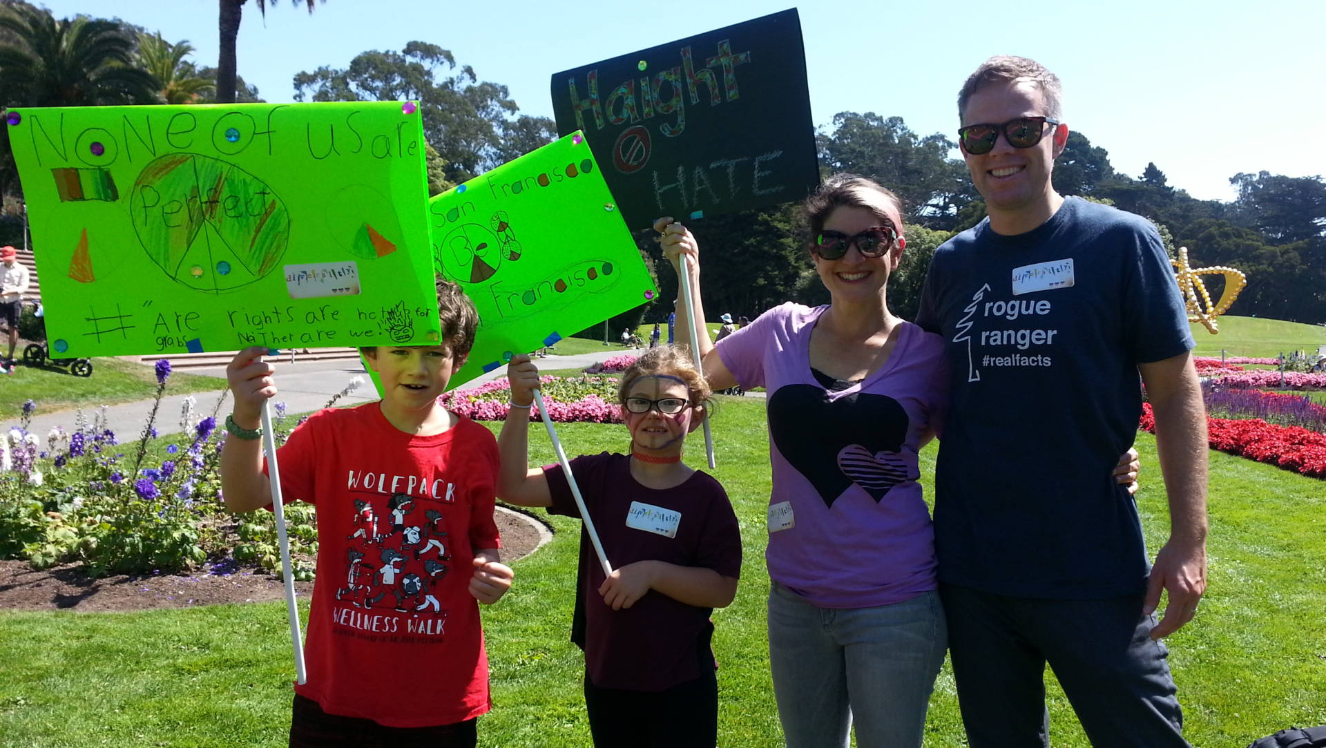 The Toberner family waves their banners at The Cutest Lil Counter Protest in Golden Gate Park. Photo: Creo Noveno/KQED