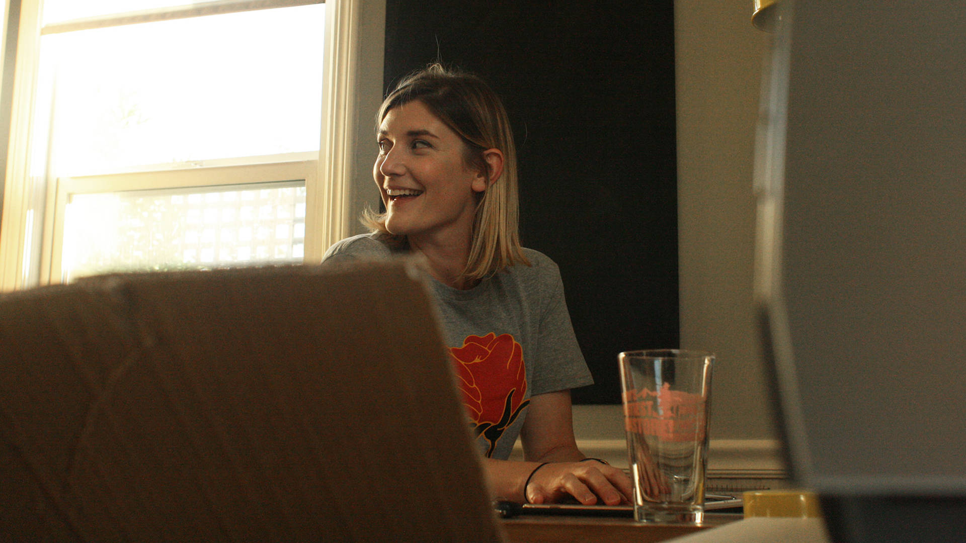 Illustrator Mikayla Butchart wearing one of her 'Rose-ilience' t-shirts in her Santa Rosa home studio. Gabe Meline/KQED