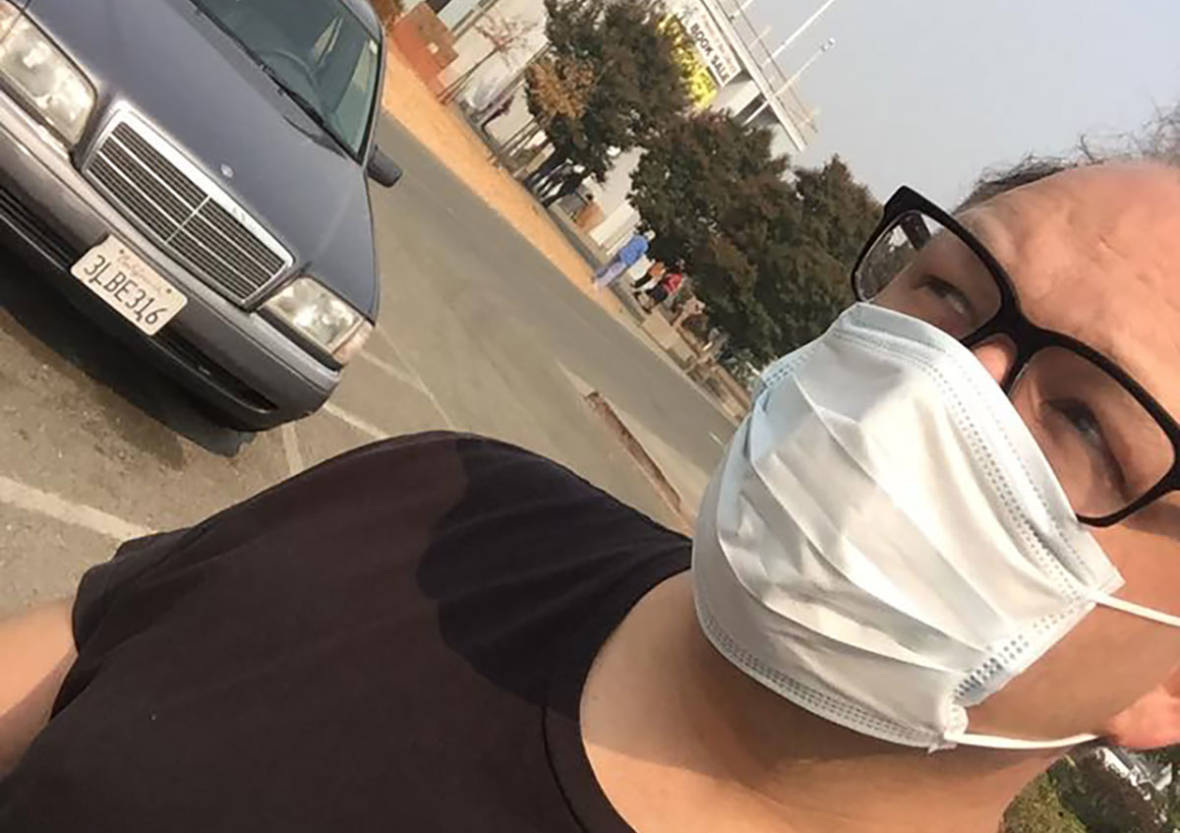Gabe Meline in a dust mask walks through the haze of smoke after evacuation. Bay Area air quality this week has been the worst on record. (Gabe Meline/KQED Arts)