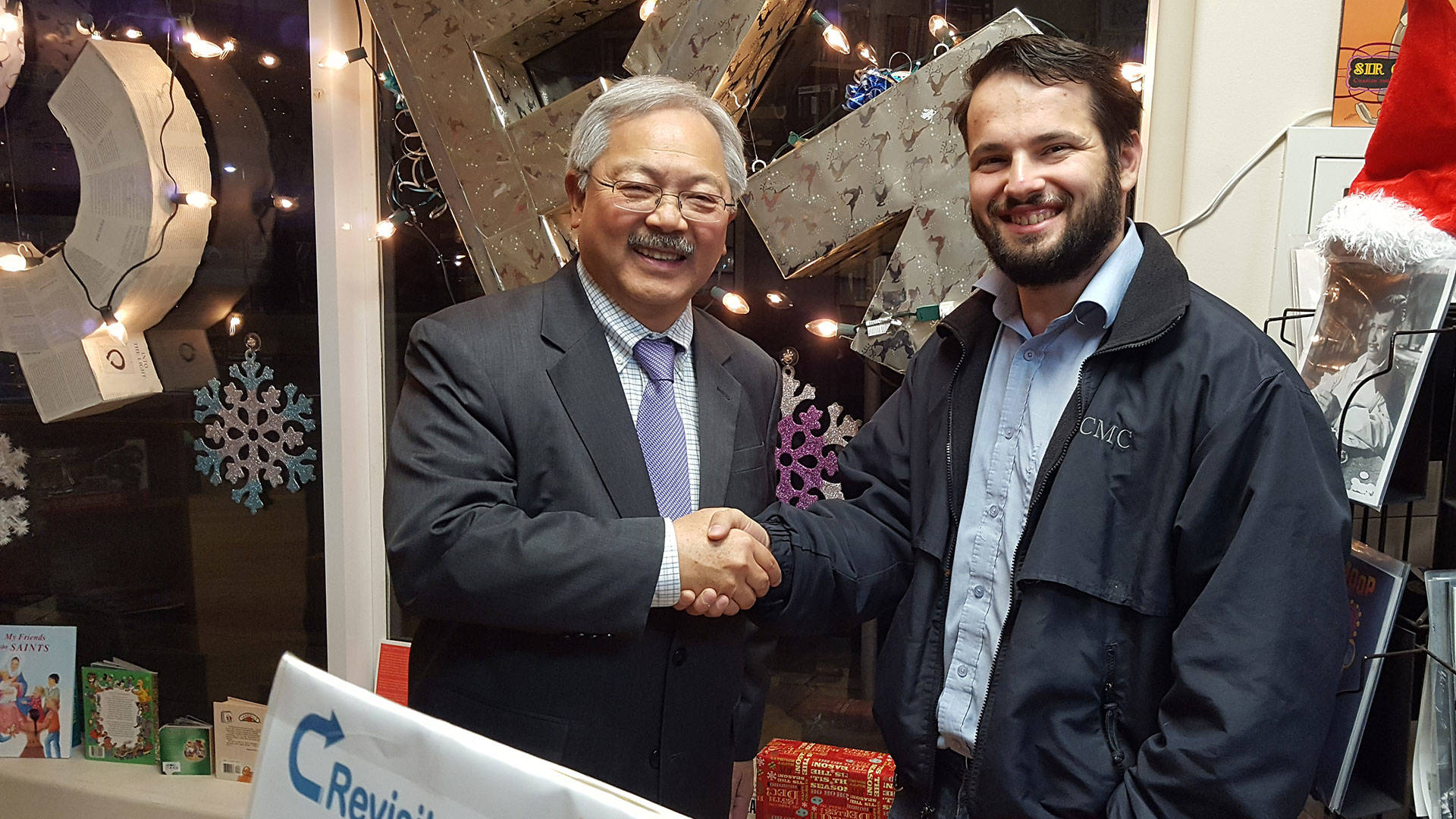 Mayor Ed Lee poses with Stevens Books owner Joseph Volansky while visiting an art installation at the bookstore on Dec. 8, three days before he died. Ezra Yu