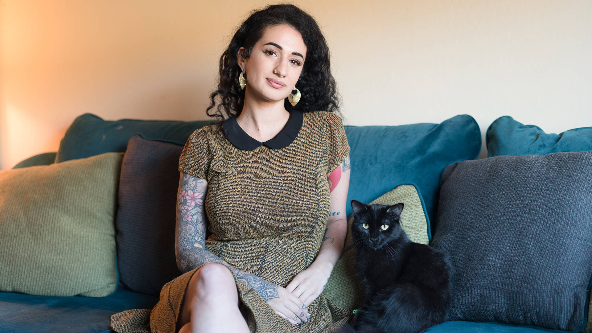 Arabelle Raphael (and one of two cats) in her East Bay home. Graham Holoch / KQED
