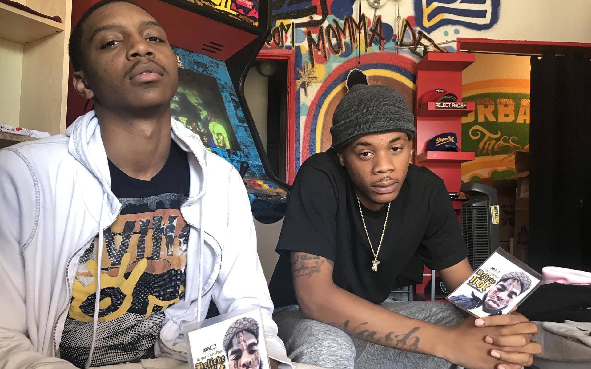 Lil Goo and Vari4Hun at Dope Era in Oakland, holding copies of their album honoring Devonte Thomas. Pendarvis Harshaw
