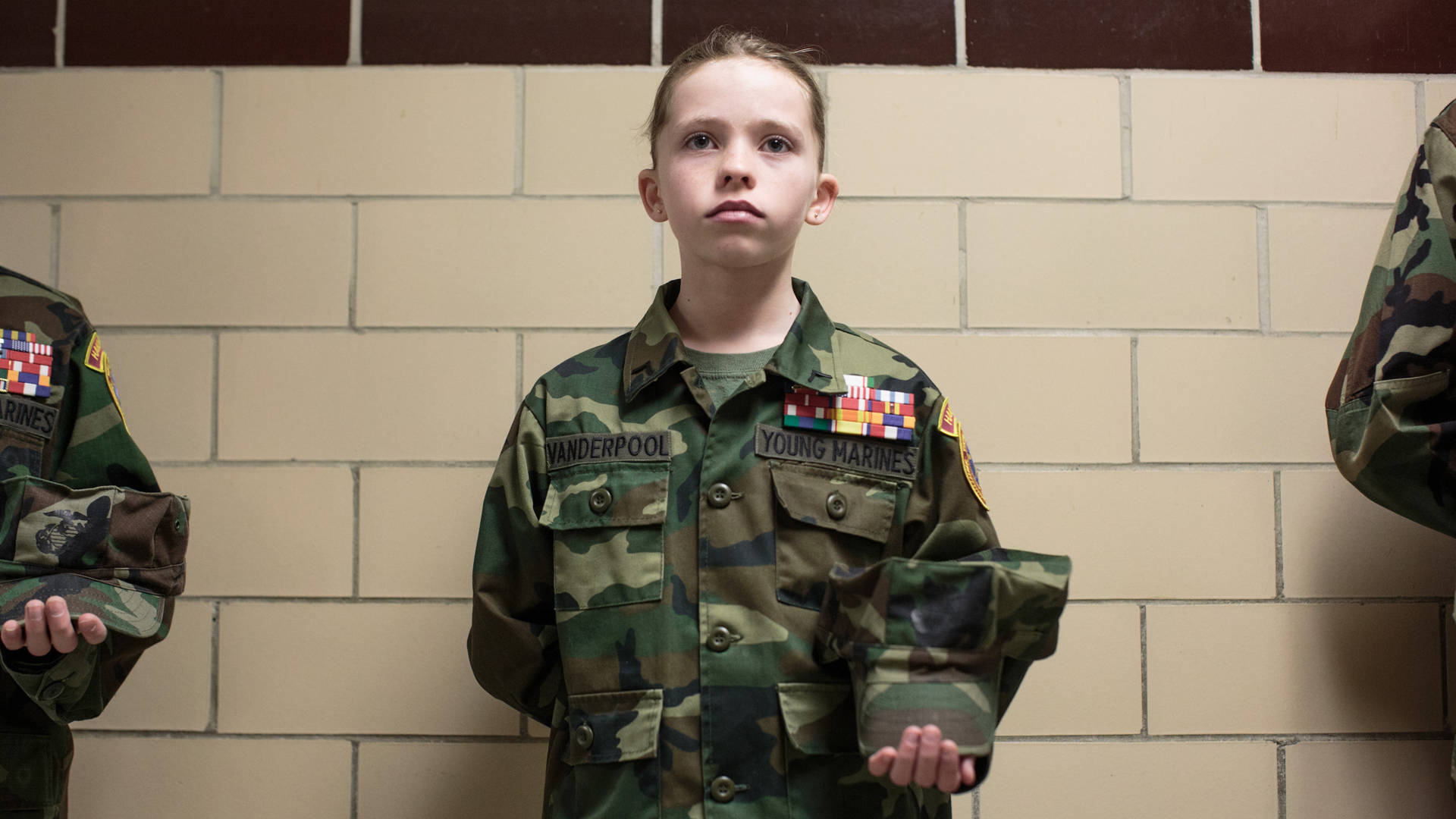 Sarah Blesener, from 'Beckon Us From Home,' 2017. An 11-year-old Young Marines recruit holds her pose during uniform inspection in Hanover, Pennsylvania. Courtesy of Sarah Blesener, 2017 CatchLight Fellow
